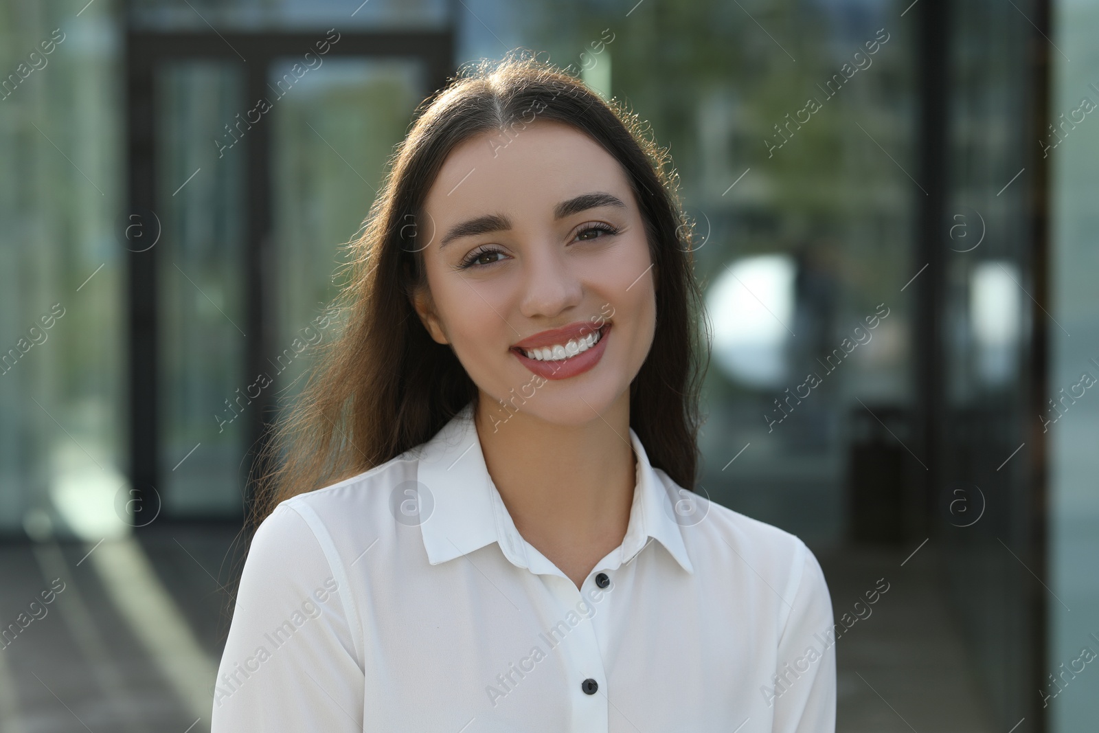 Photo of Portrait of beautiful woman outdoors. Attractive lady smiling and looking into camera