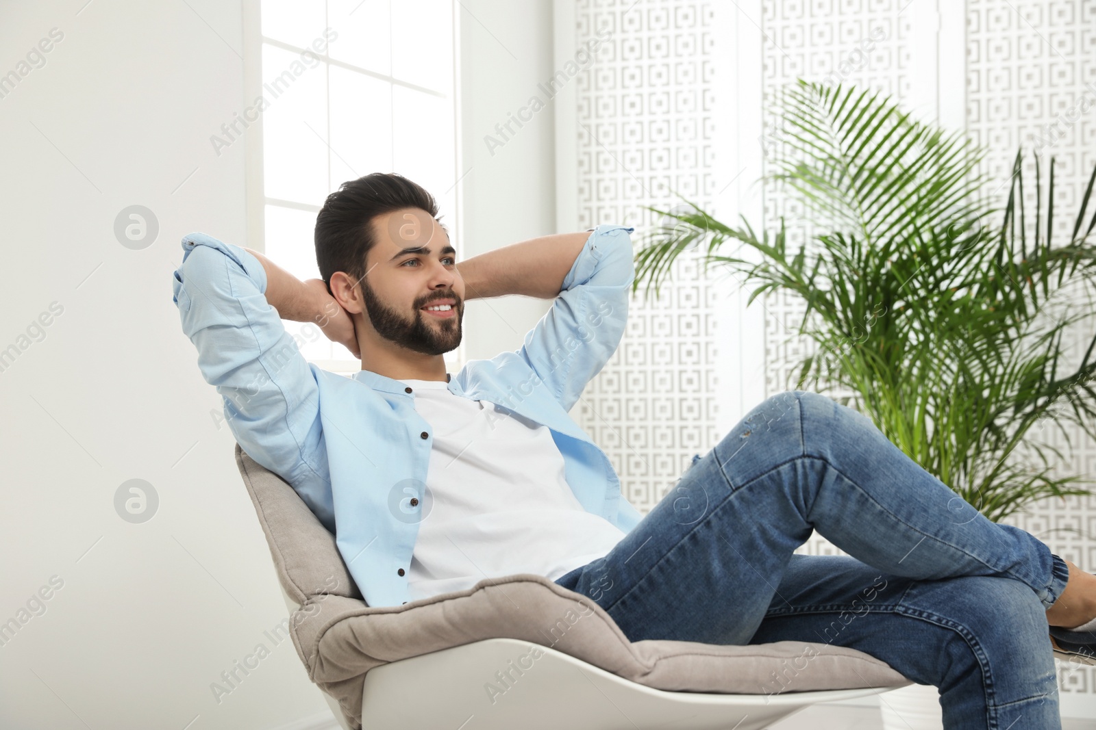 Photo of Young man relaxing at home. Peaceful rest