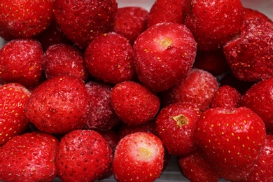 Pile of frozen strawberries as background, closeup