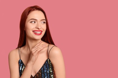 Photo of Happy woman with red dyed hair on pink background, space for text