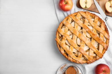 Photo of Delicious traditional apple pie on white table, flat lay. Space for text