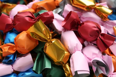 Many candies in colorful wrappers as background, closeup