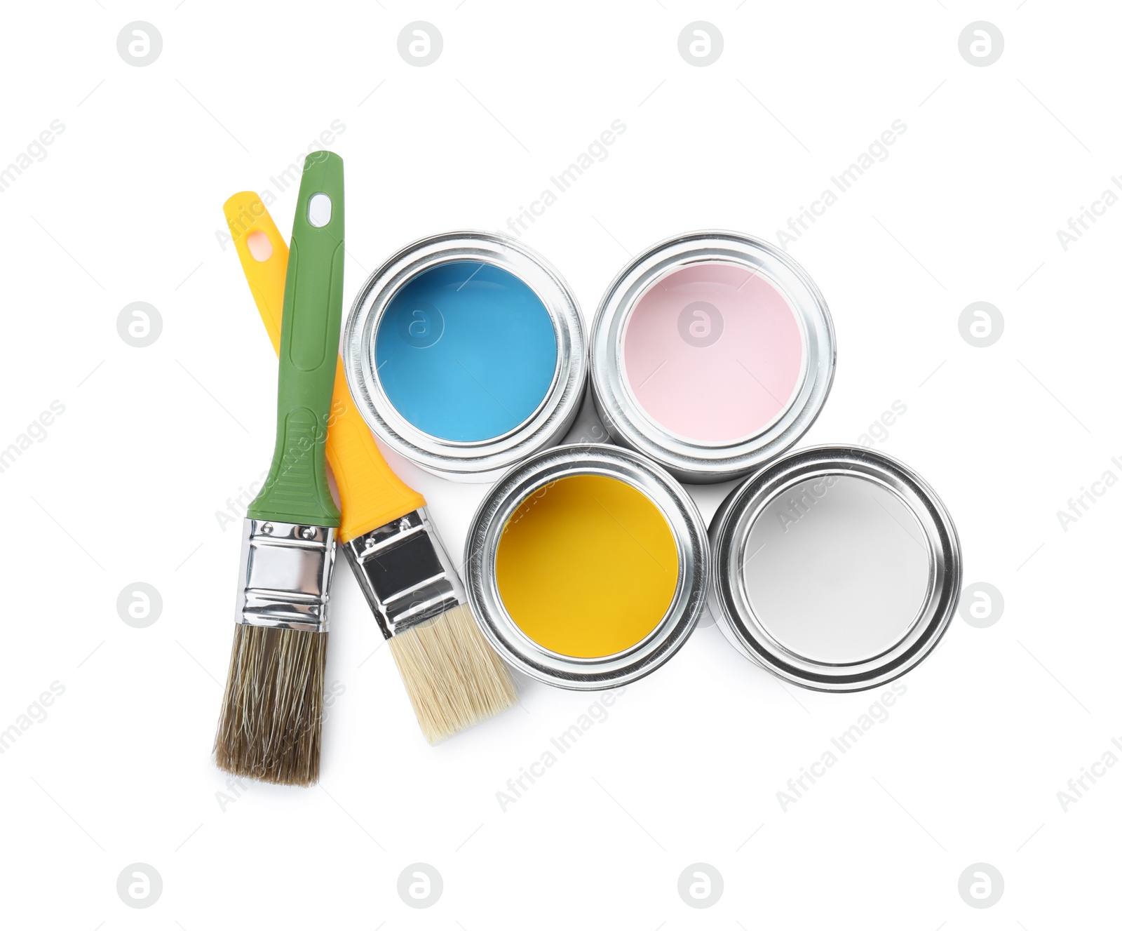 Photo of Cans of colorful paints and brushes isolated on white, top view