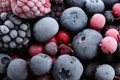 Photo of Mix of different frozen berries as background, top view