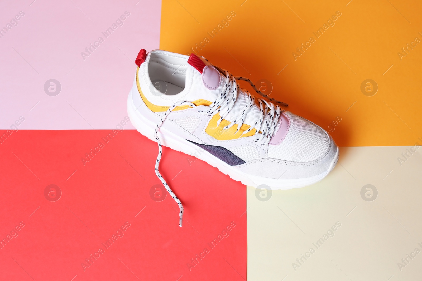 Photo of Single new stylish sneaker on color background