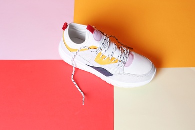 Photo of Single new stylish sneaker on color background