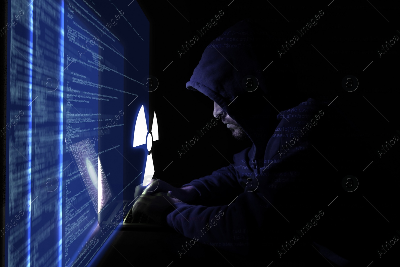 Image of Nuclear deterrence. Hacker using computer in darkness, virtual screen with code and warning radiation symbol