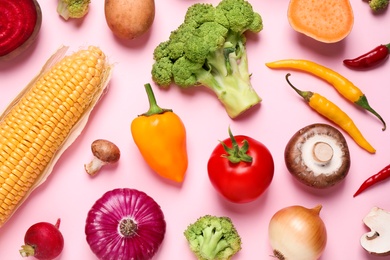 Photo of Flat lay composition with fresh vegetables on pink background