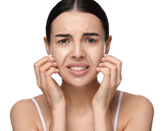 Woman with dry skin scratching her face on white background