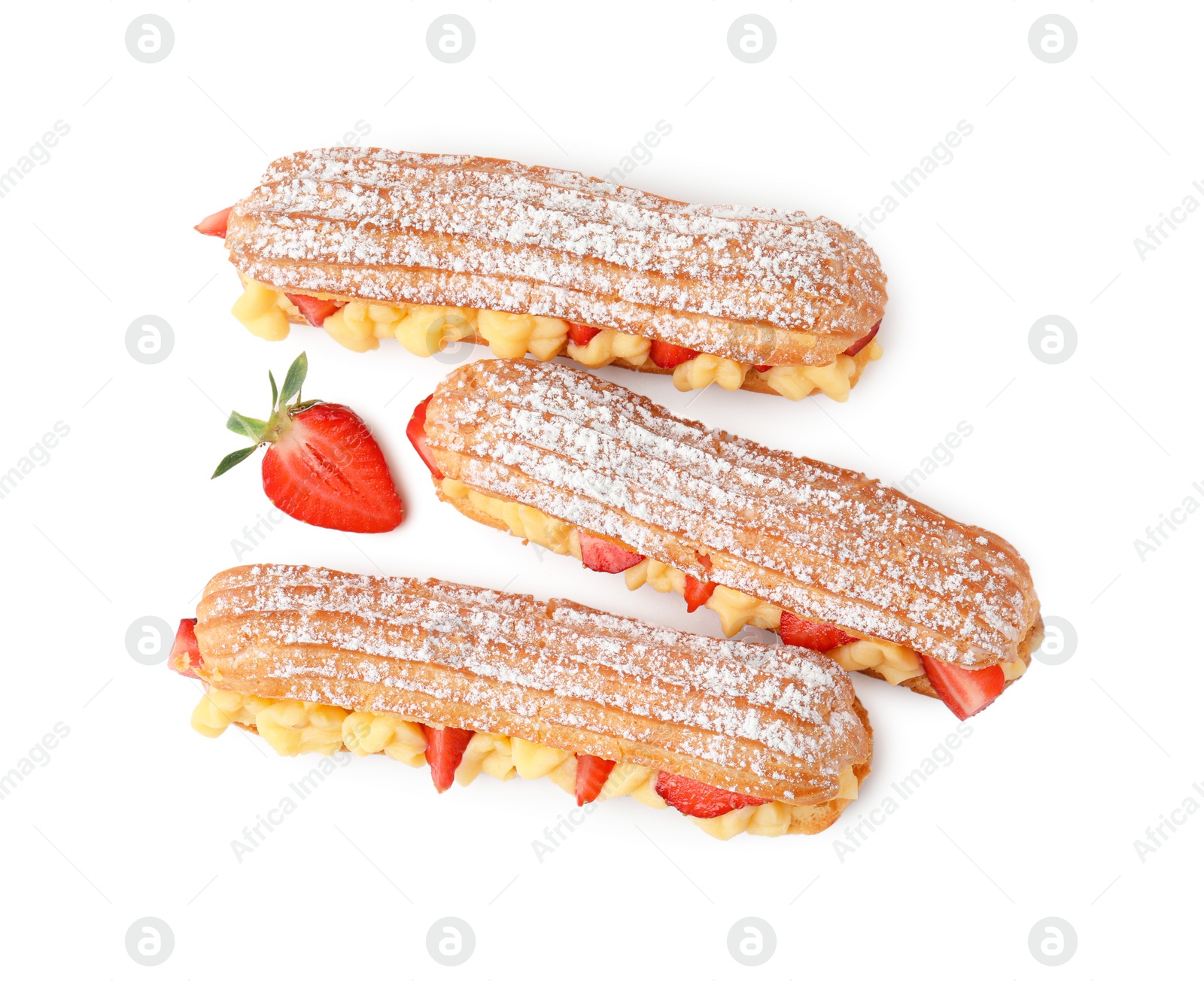 Photo of Delicious eclairs filled with cream and strawberries isolated on white, top view