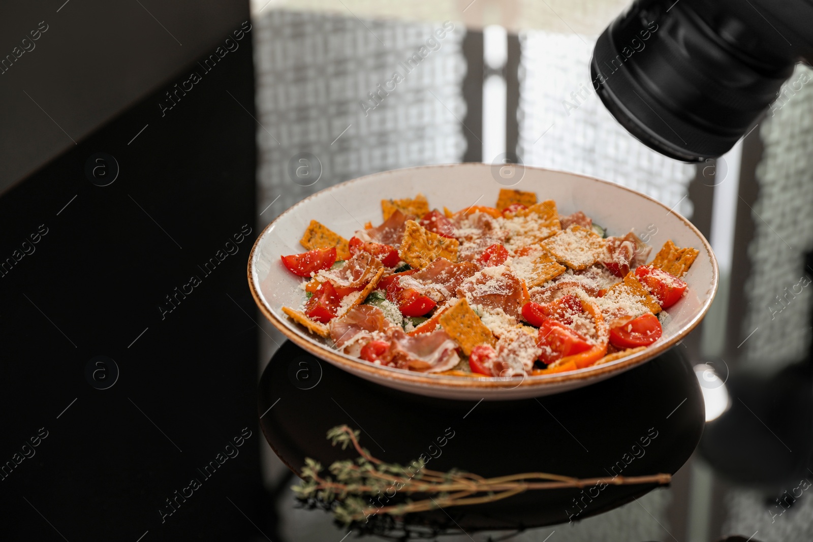 Photo of Composition of salad with prosciutto in photo studio. Food photography