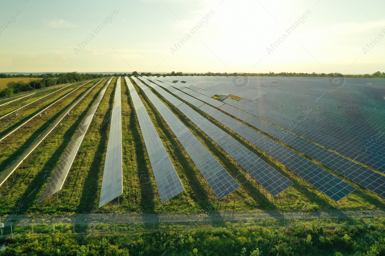 Photo of Solar panels installed outdoors, aerial view. Alternative energy source