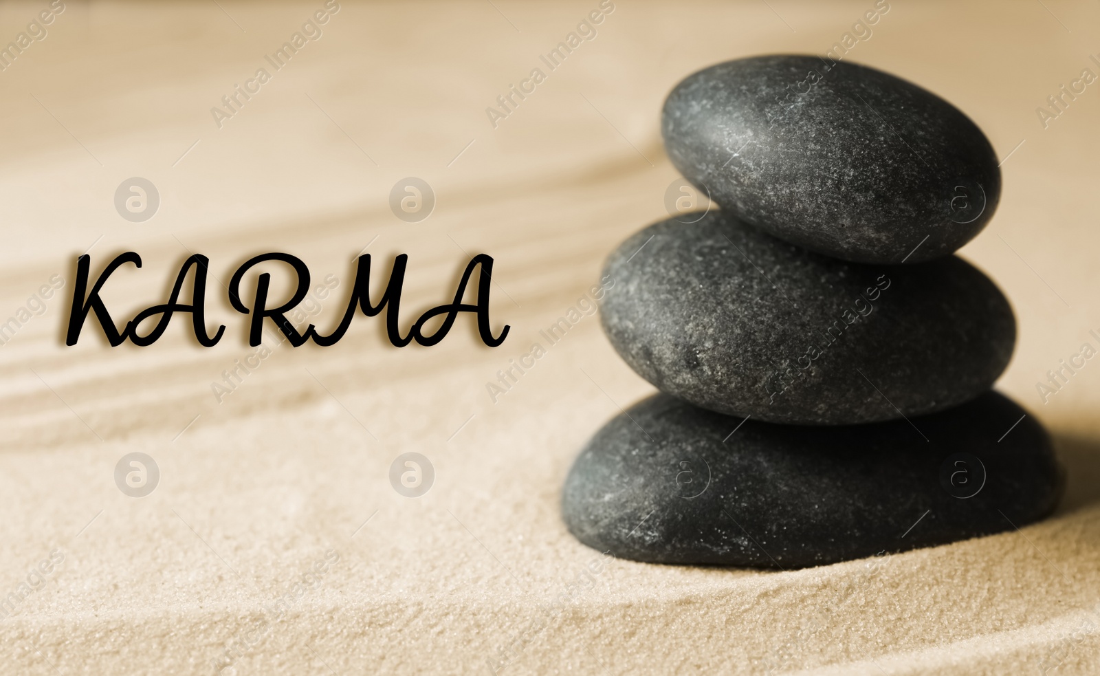 Image of Karma concept. Stacked stones on sand, closeup