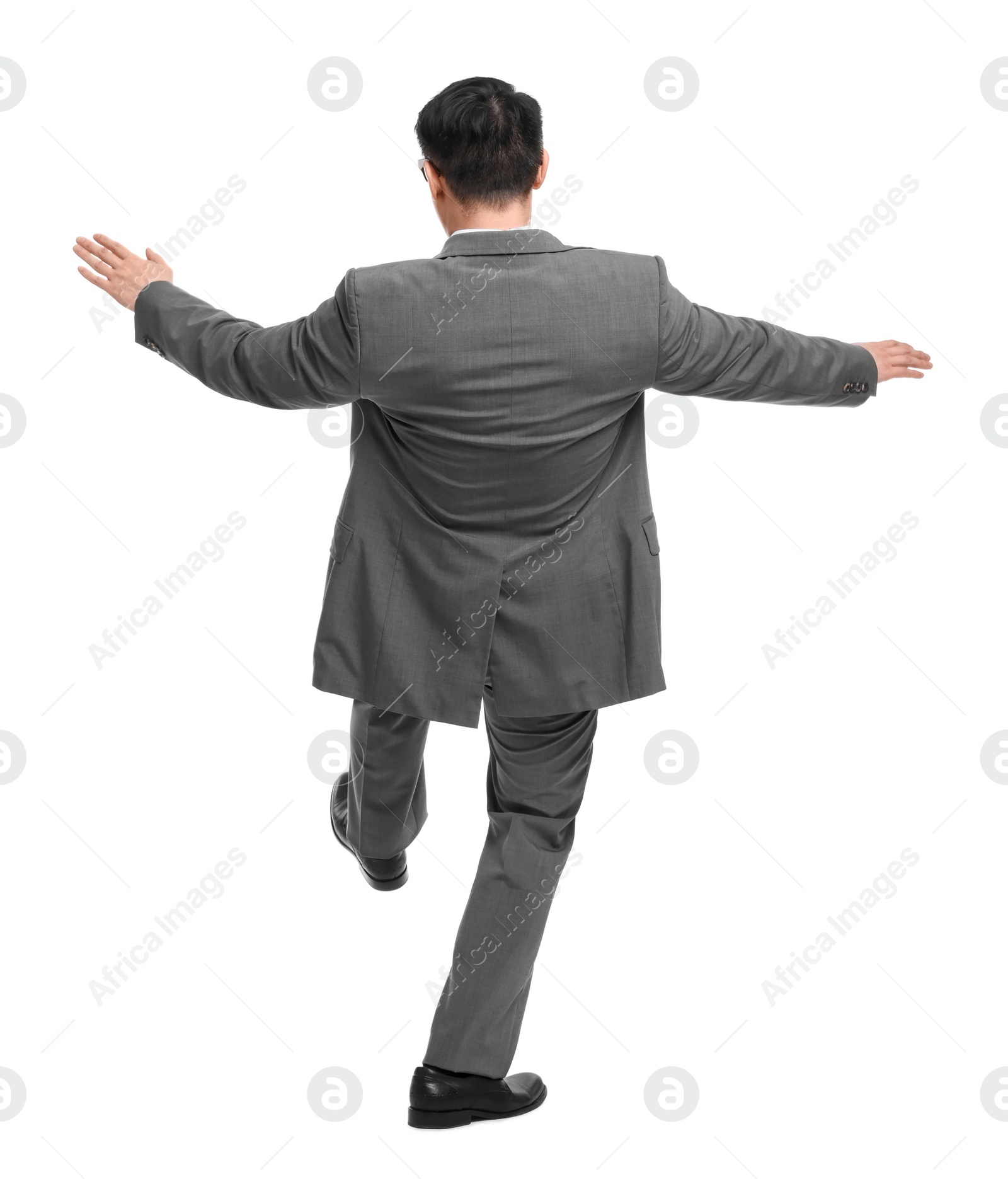 Photo of Businessman in suit posing on white background, back view