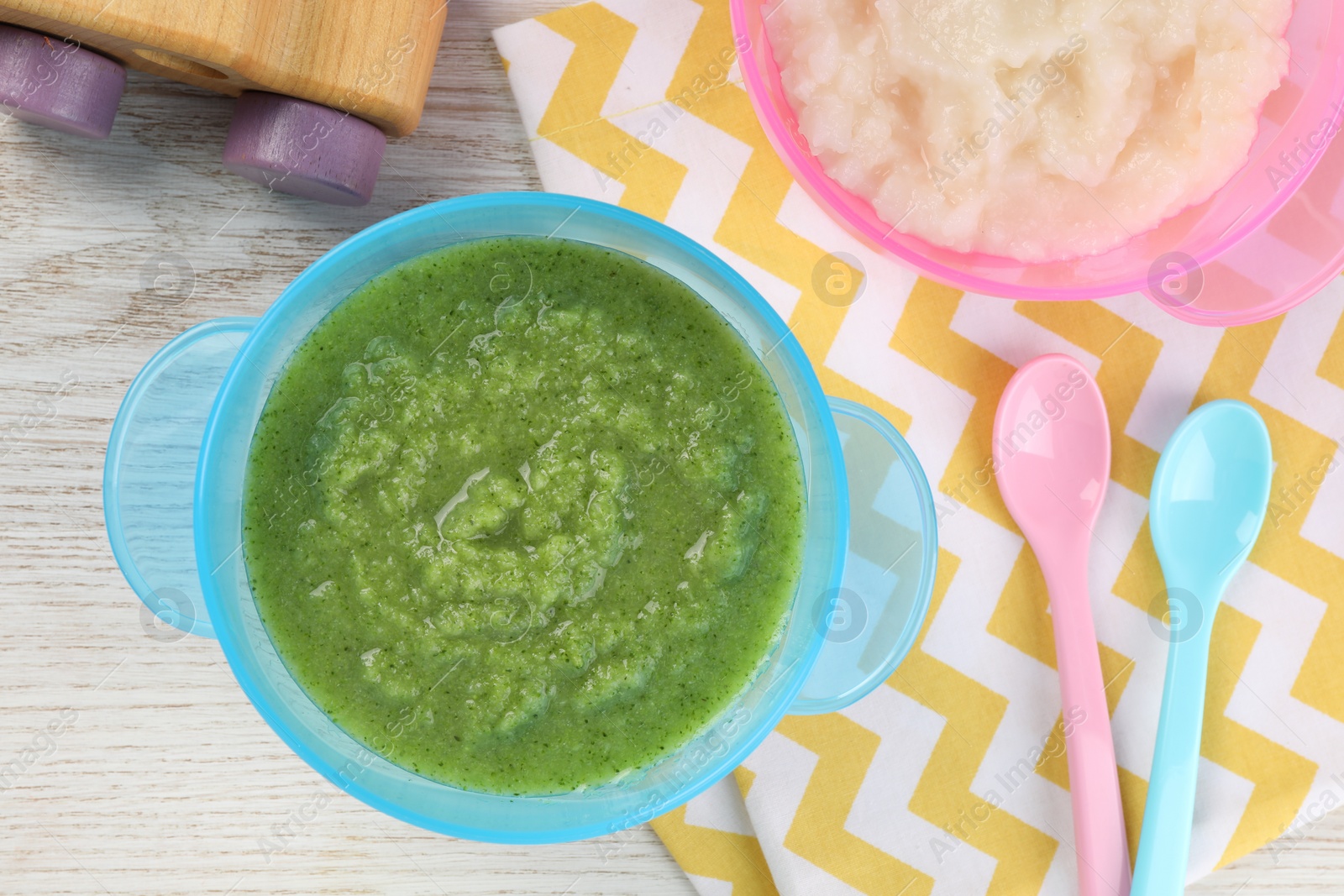 Photo of Healthy baby food. Different tasty puree in bowls on white wooden table, flat lay