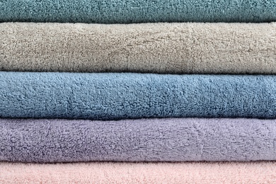 Stack of clean terry towels as background