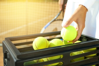 Photo of Sportswoman playing tennis at court on sunny day, closeup