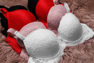 Photo of Beautiful lace bras on faux fur. Stylish underwear