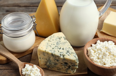 Different dairy products on wooden table, closeup