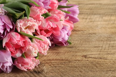 Beautiful bouquet of colorful tulip flowers on wooden table