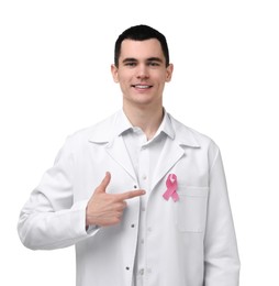 Portrait of smiling mammologist pointing at pink ribbon on white background. Breast cancer awareness