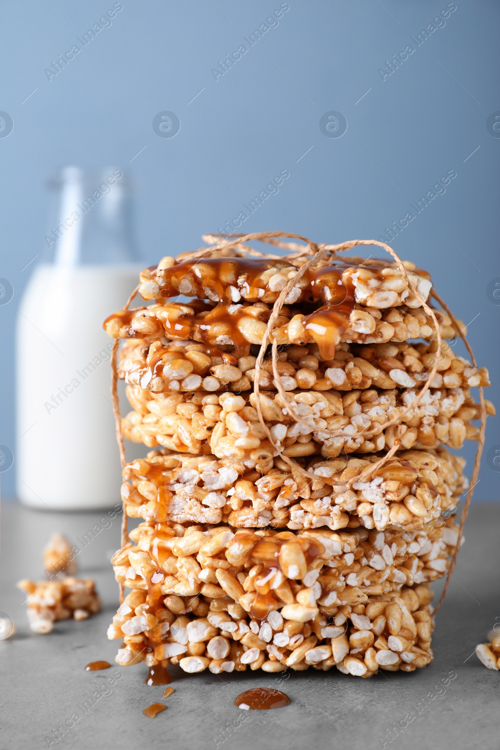 Photo of Delicious rice crispy treats on grey table