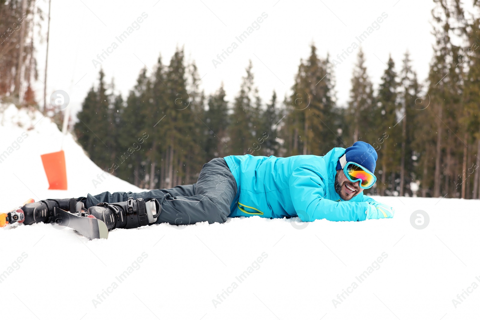 Photo of Clumsy skier on slope at resort. Winter vacation