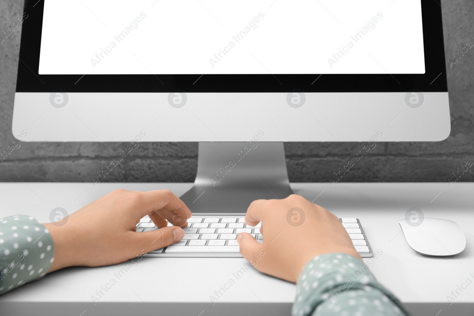 Photo of Woman working on computer at white table, closeup. Mockup for design