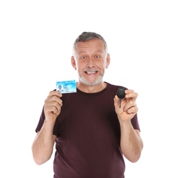 Photo of Happy mature man with driving license and car key on white background