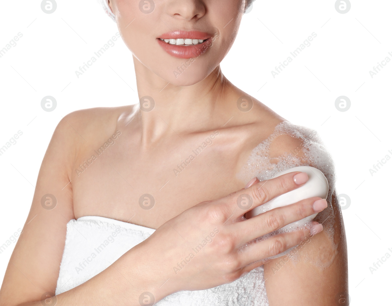 Photo of Young woman washing body with soap bar on white background