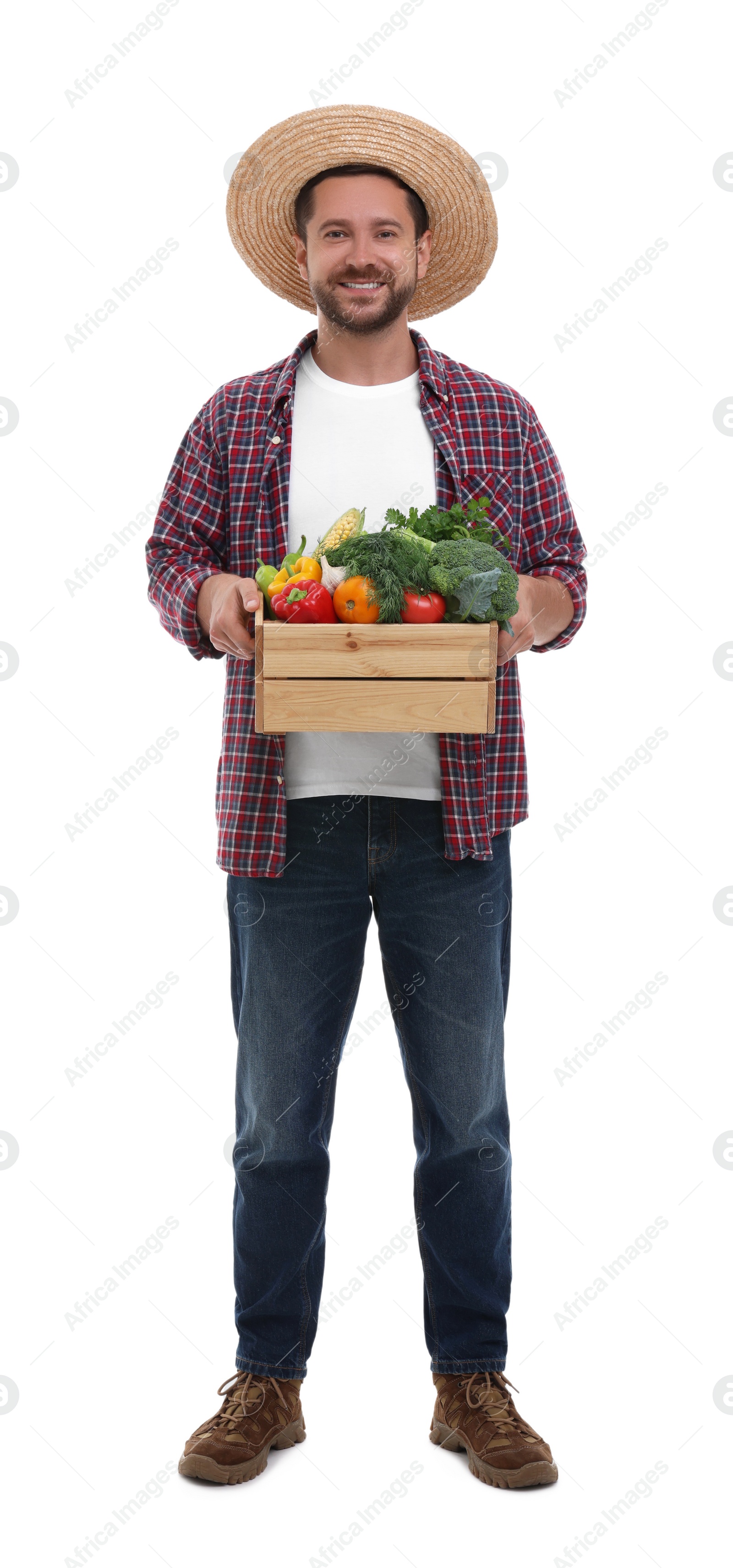 Photo of Harvesting season. Happy farmer holding wooden crate with vegetables on white background