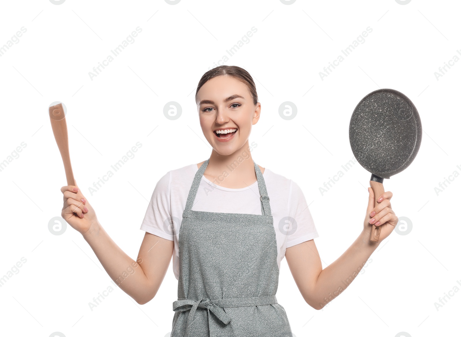 Photo of Beautiful young woman in striped apron with kitchen tools on white background