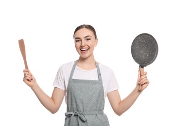 Photo of Beautiful young woman in striped apron with kitchen tools on white background