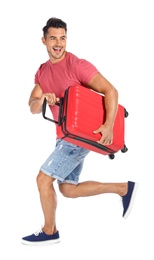 Photo of Young man running with suitcase on white background