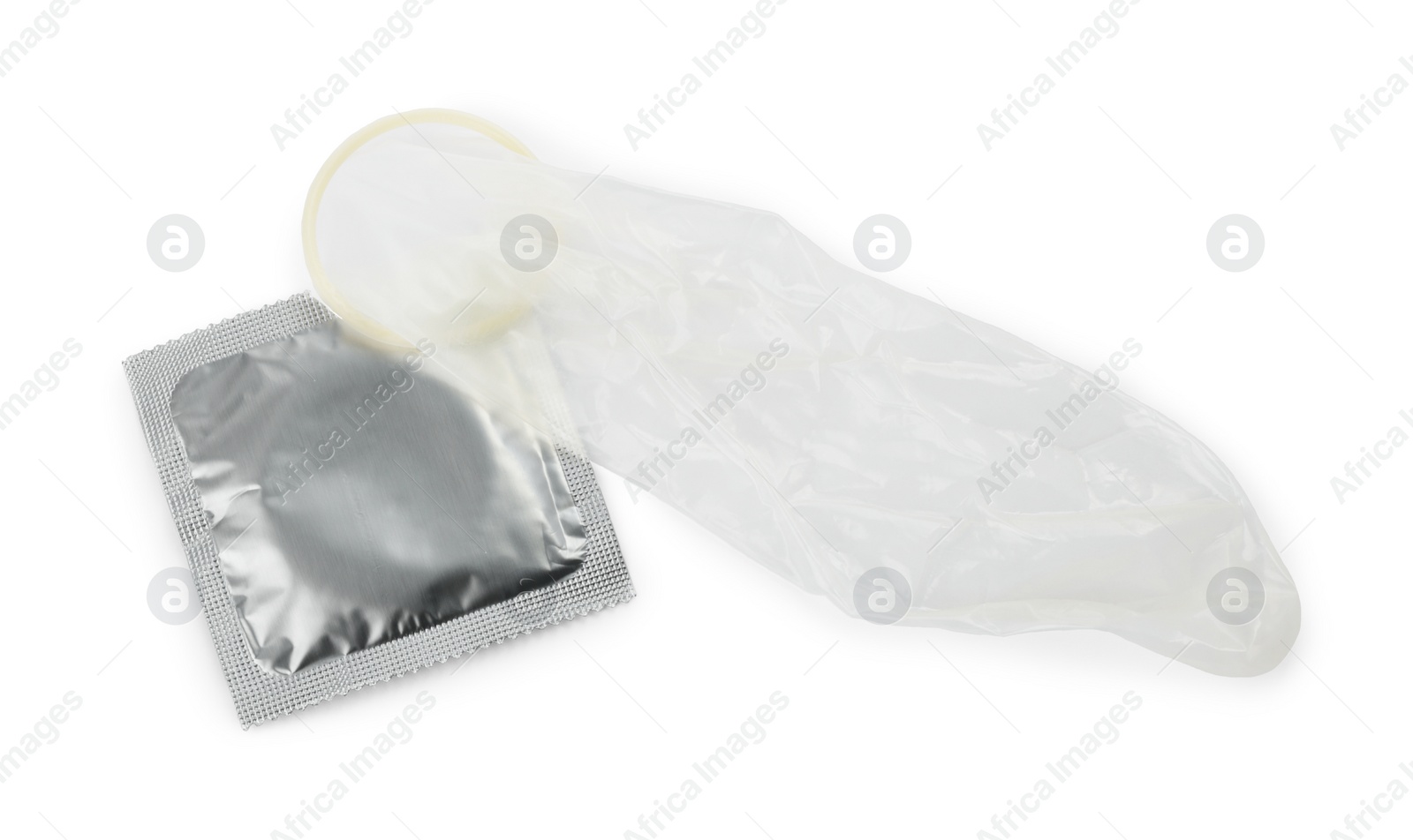 Photo of Unrolled condom and package on white background, top view. Safe sex