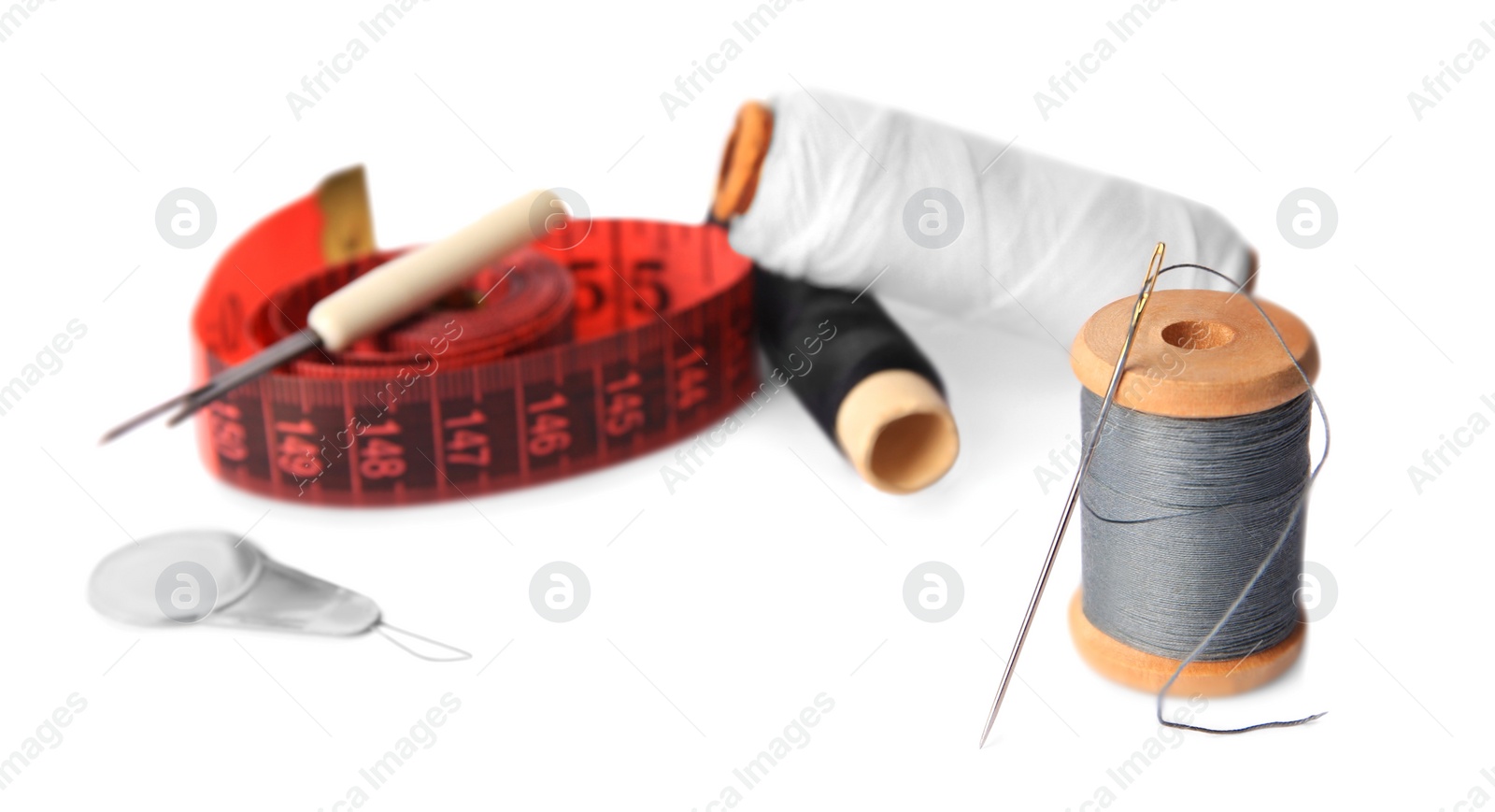 Photo of Set of sewing accessories on white background