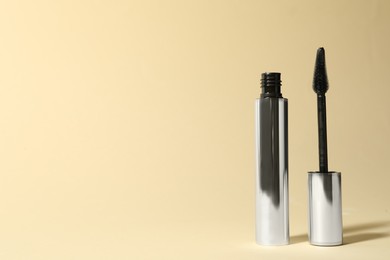 Mascara on beige background, space for text