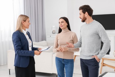 Photo of Real estate agent showing new apartment to couple