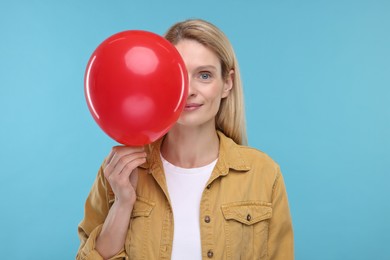 Photo of Woman with air balloon on light blue background