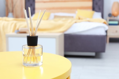 Reed freshener on table in bedroom