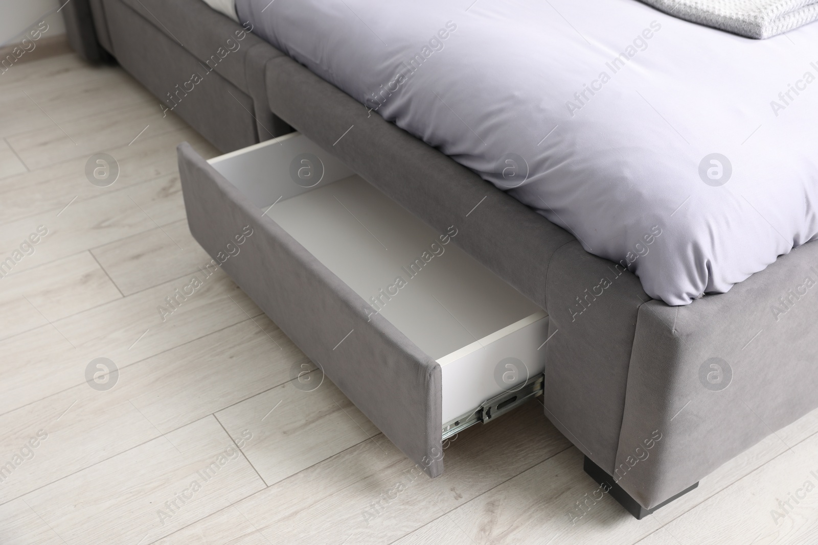 Photo of Storage drawer for bedding under modern bed in room