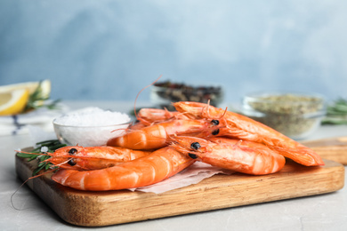 Delicious cooked shrimps on grey marble table