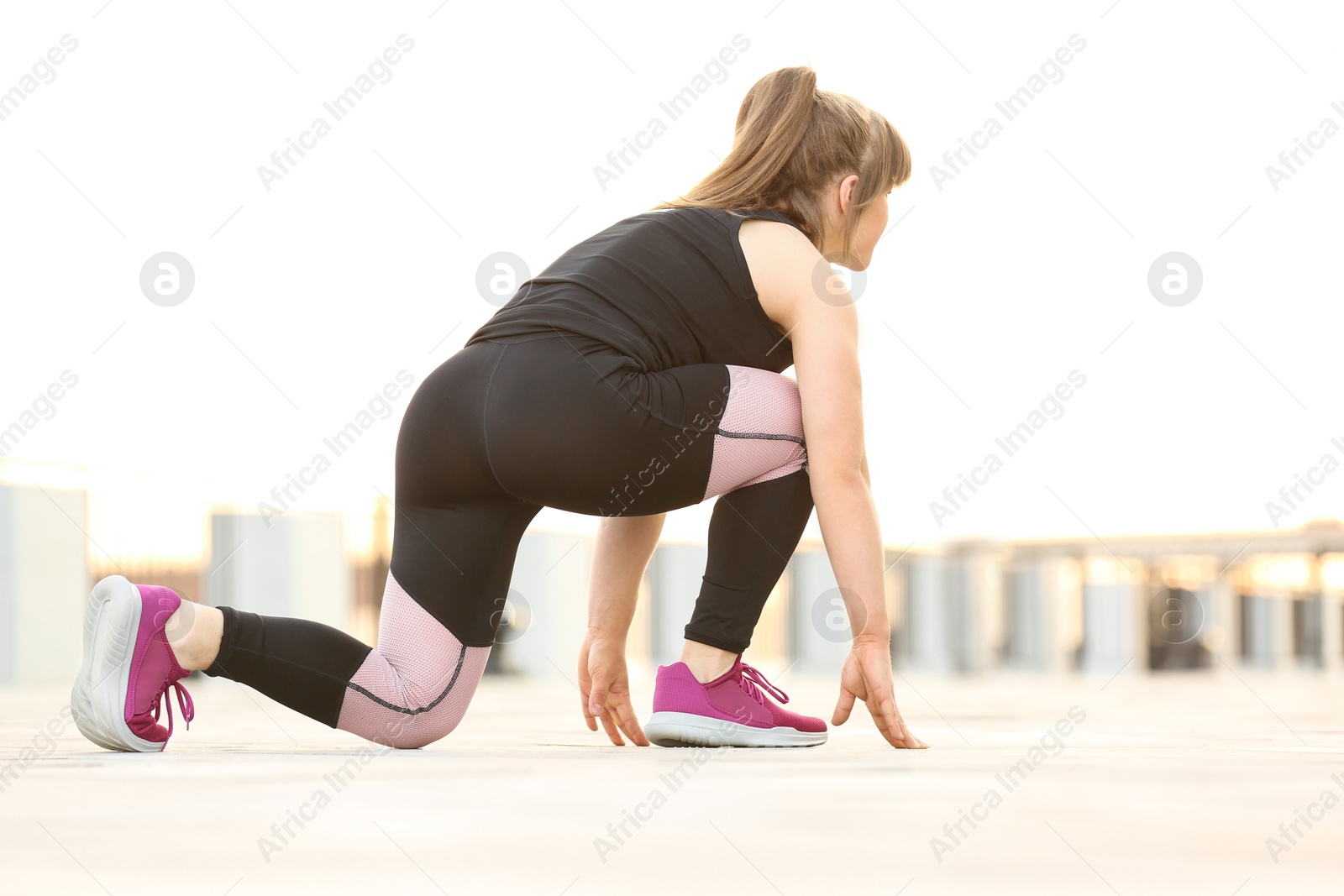 Photo of Young woman ready for running outdoors on sunny day