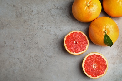 Photo of Fresh tasty grapefruits on table, top view with space for text