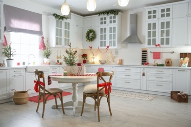 Small Christmas trees and festive decor in kitchen