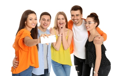 Photo of Young happy friends taking selfie against white background