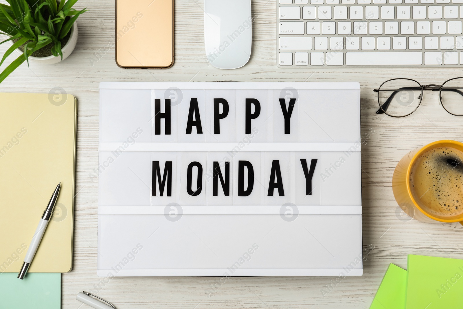 Photo of Flat lay composition of lightbox with phrase Happy Monday at workplace