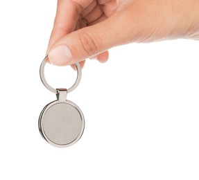 Photo of Woman holding metallic keychain on white background, closeup