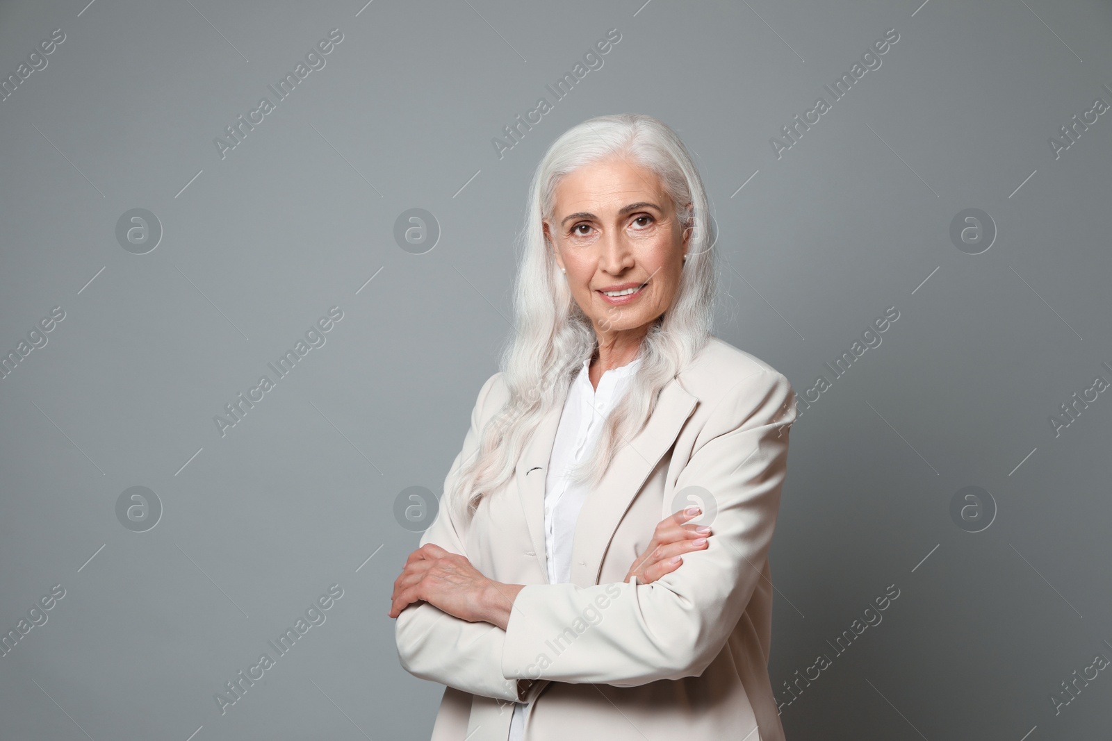 Photo of Portrait of beautiful mature woman on grey background, space for text