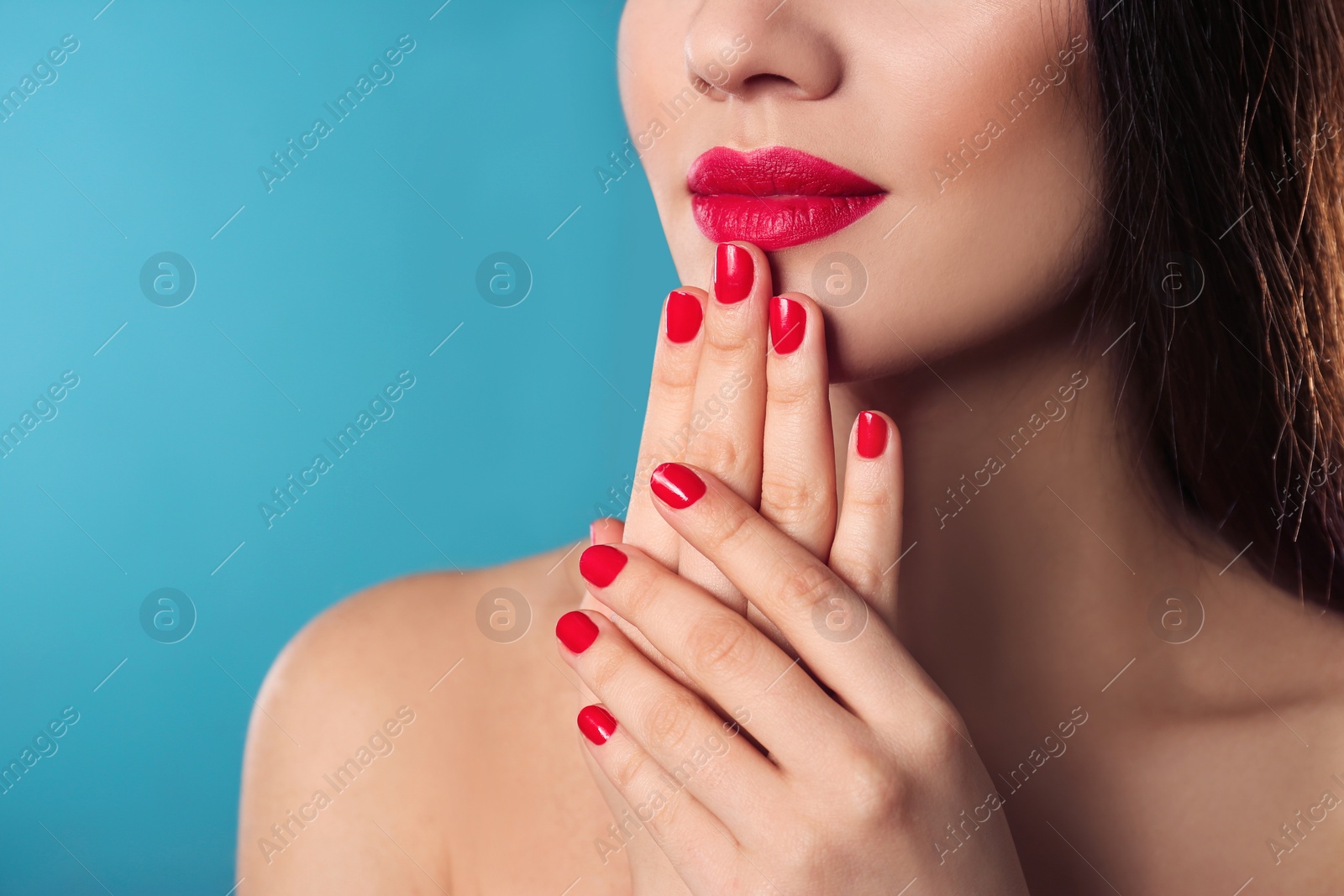 Photo of Beautiful woman with stylish nail polish on color background, closeup. Space for text